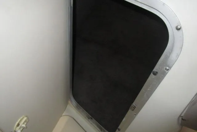 Slide: The Image of 2004 Stingray 240 LR boat interior compartment with open hatch. - 18