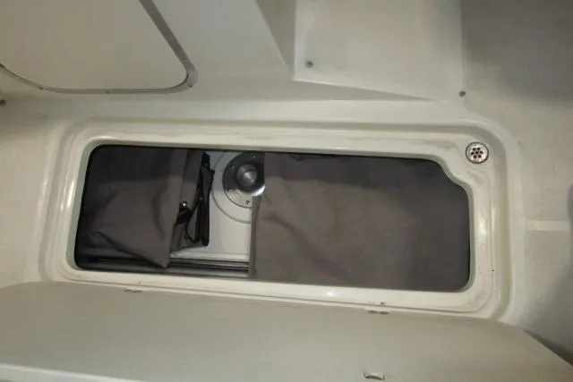 Slide: The Image of Storage compartment in a 2004 Stingray 240 LR boat interior. - 20
