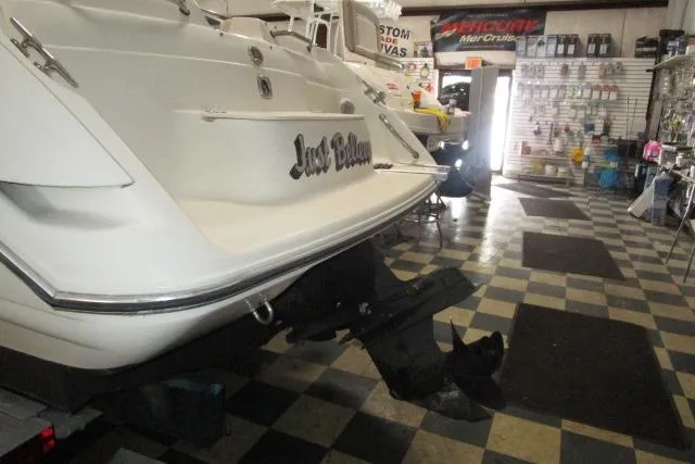 Slide: The Image of 2004 Stingray 240 LR boat in showroom, checkered floor, rear view. - 23