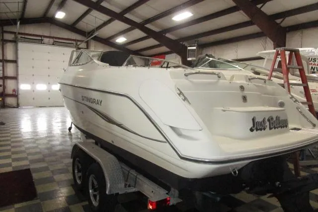 Slide: The Image of 2004 Stingray 240 LR boat in indoor storage on a trailer. - 5