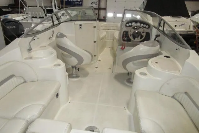 Slide: The Image of 2004 Stingray 240 LR boat interior with seating, steering wheel, and dashboard. - 6