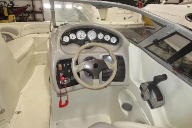 Slide: The Image of 2004 Stingray 240 LR boat interior with steering wheel and dashboard controls. - 9