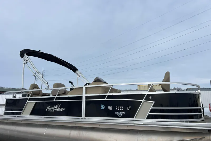 The Image of 2019 SunChaser Geneva Fish 20 Cnf pontoon boat with canopy, docked outdoors. - 0