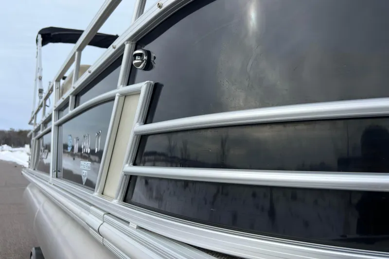 Slide: The Image of 2019 SunChaser Geneva Fish 20 Cnf pontoon boat, close-up side view with sleek design. - 14