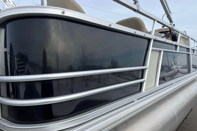 Slide: The Image of 2019 SunChaser Geneva Fish 20 Cnf pontoon boat with sleek black paneling and silver rails. - 17