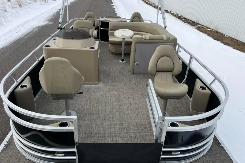 Slide: The Image of 2019 SunChaser Geneva Fish 20 Cnf pontoon boat with beige seating and fishing setup. - 2