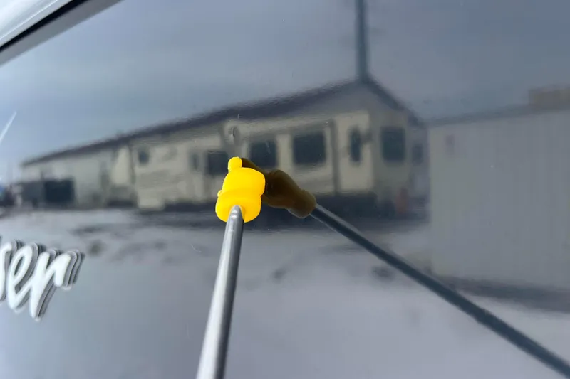 Slide: The Image of Close-up of a 2019 SunChaser Geneva Fish 20 Cnf with a yellow tool on its surface. - 21