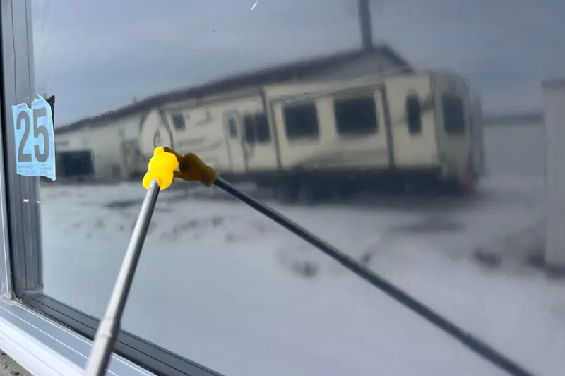 Slide: The Image of Reflection of a trailer on a window with a yellow cleaning tool. - 22