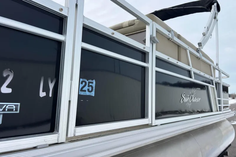 Slide: The Image of 2019 SunChaser Geneva Fish 20 Cnf pontoon boat, side view with logo and registration details. - 23