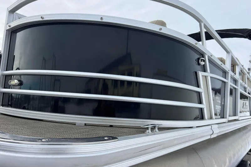 Slide: The Image of 2019 SunChaser Geneva Fish 20 Cnf pontoon boat, sleek black exterior, silver railings. - 24