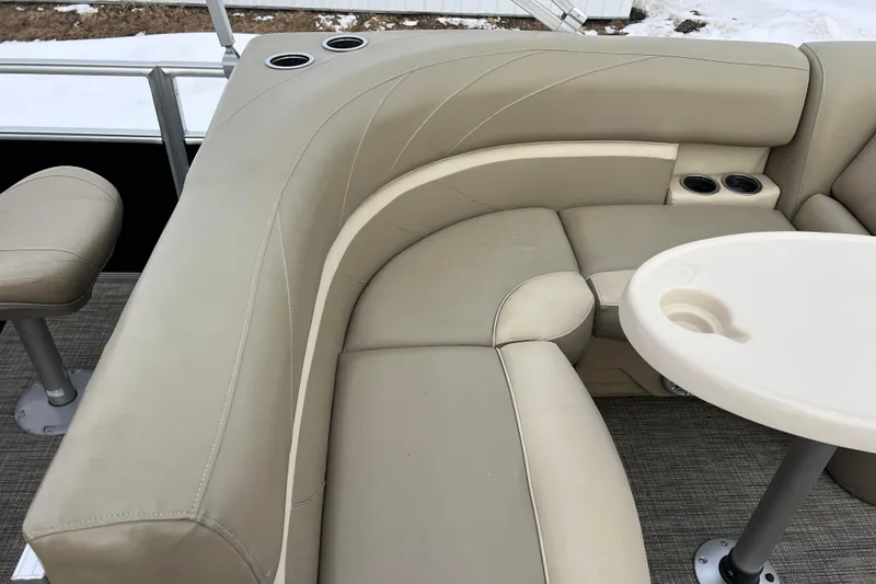 Slide: The Image of 2019 SunChaser Geneva Fish 20 Cnf boat interior with beige seating and cup holders. - 34