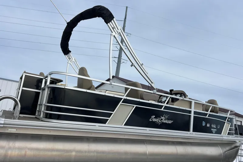 Slide: The Image of 2019 SunChaser Geneva Fish 20 Cnf pontoon boat with sleek black design and comfortable seating. - 4