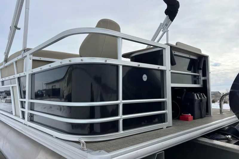 Slide: The Image of 2019 SunChaser Geneva Fish 20 Cnf pontoon boat, side view with seating and railing. - 9