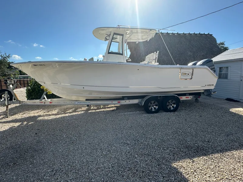 The Image of 2021 Sea Hunt Gamefish 27 boat on trailer outdoors. - 0
