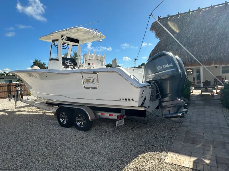 Slide: The Image of 2021 Sea Hunt Gamefish 27 boat with Yamaha engine on trailer. - 2