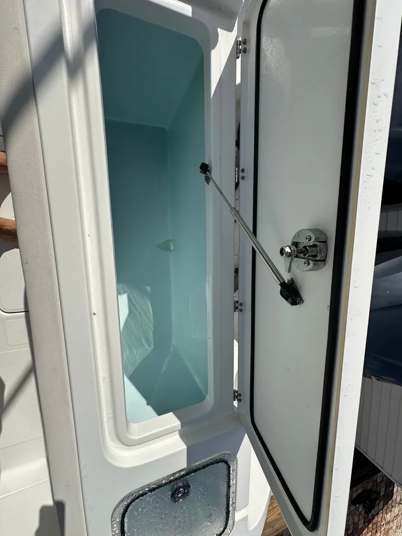 Slide: The Image of Open storage compartment on a 2021 Sea Hunt Gamefish 27 boat. - 24