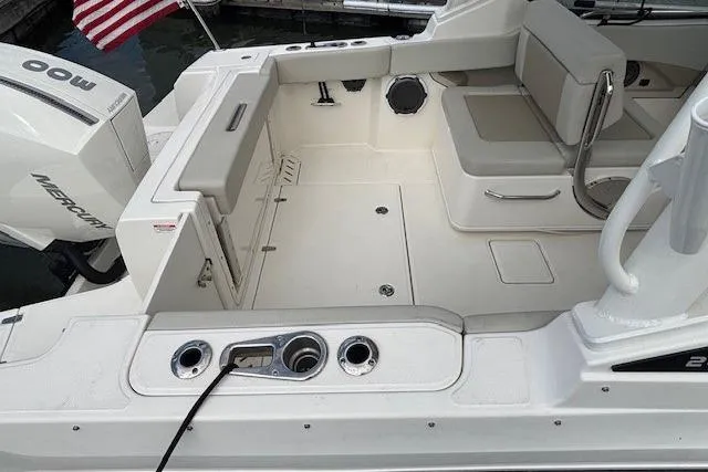 Slide: The Image of 2022 Boston Whaler 240 Vantage boat interior with seating and Mercury engine. - 14