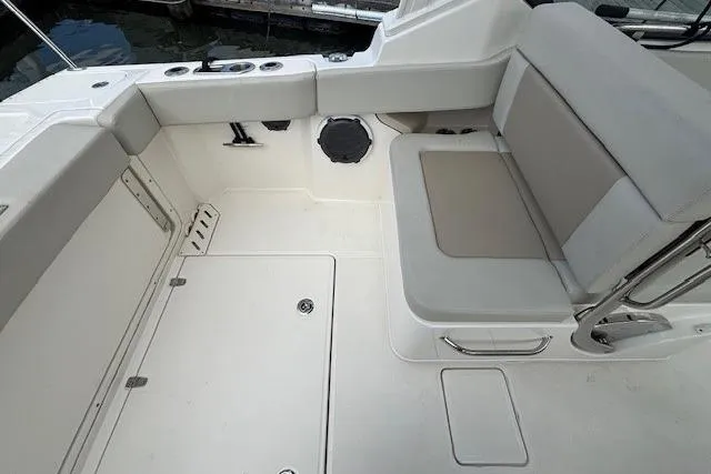 Slide: The Image of 2022 Boston Whaler 240 Vantage boat interior with cushioned seating and storage compartments. - 17