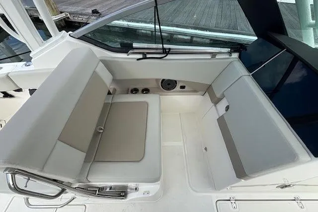 Slide: The Image of 2022 Boston Whaler 240 Vantage boat interior with cushioned seating and sleek design. - 19