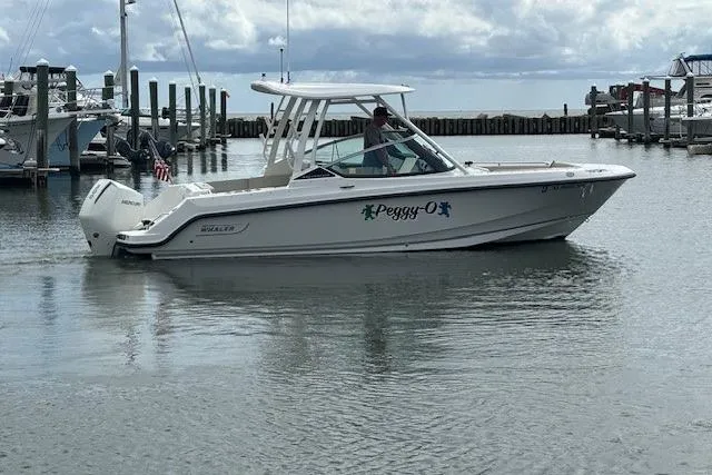Slide: The Image of 2022 Boston Whaler 240 Vantage boat named "Peggy-O" docked in a marina. - 2