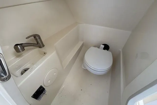 Slide: The Image of 2022 Boston Whaler 240 Vantage boat interior with compact bathroom and sink. - 20