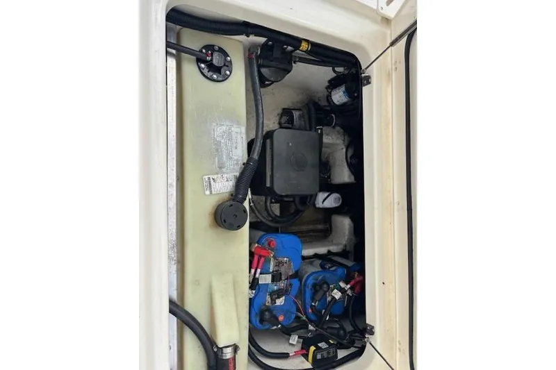 Slide: The Image of 2022 Boston Whaler 240 Vantage engine compartment with wiring and components. - 22