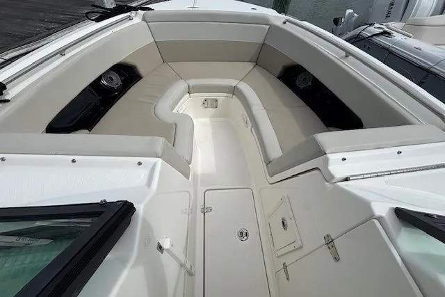 Slide: The Image of 2022 Boston Whaler 240 Vantage boat interior with cushioned seating and storage compartments. - 6