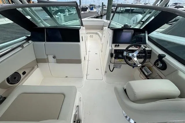 Slide: The Image of 2022 Boston Whaler 240 Vantage boat interior with helm, seating, and navigation equipment. - 7