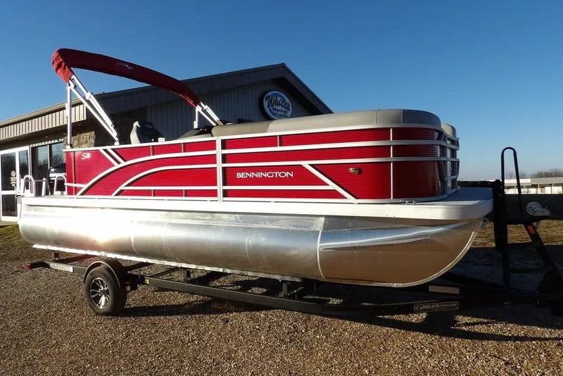The Image of 2026 Bennington 21 S L-Bench pontoon boat with red exterior on trailer. - 1