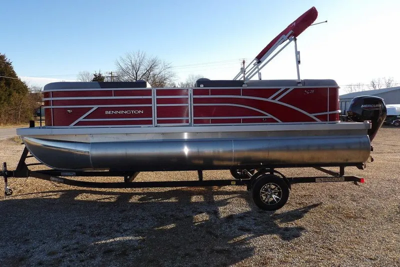 Slide: The Image of 2026 Bennington 21 S L-Bench pontoon boat with red exterior on a trailer. - 10
