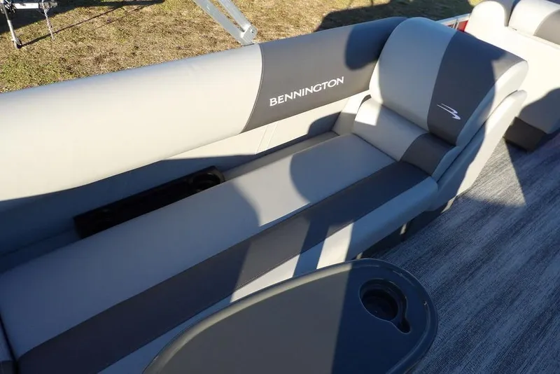 Slide: The Image of 2026 Bennington 21 S L-Bench boat interior with gray seating and cup holder. - 21