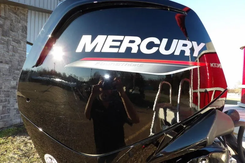 Slide: The Image of Mercury FourStroke engine on 2026 Bennington 21 S L-Bench boat, reflecting outdoor scenery. - 29