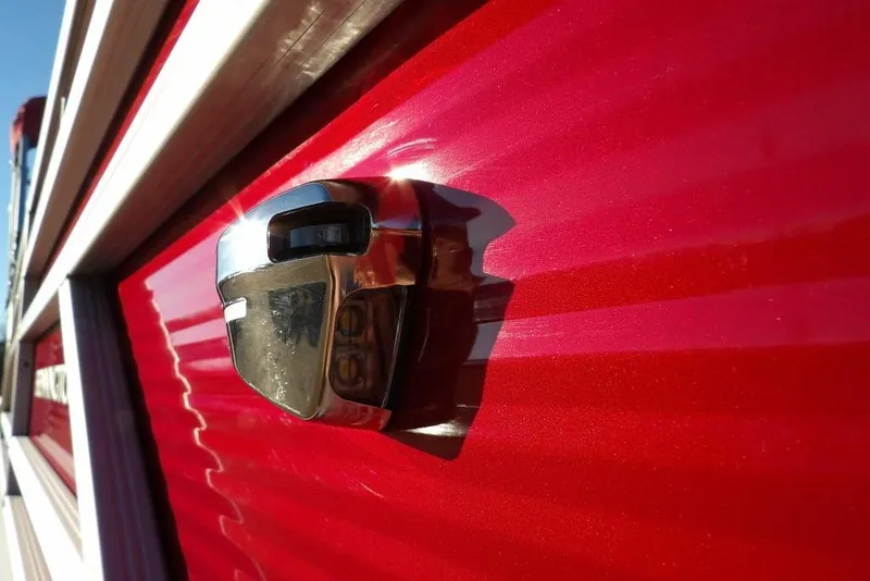 Slide: The Image of Close-up of a 2026 Bennington 21 S L-Bench boat's shiny red exterior detail. - 34