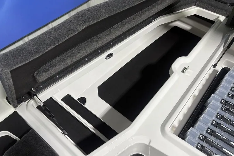 Slide: The Image of Storage compartment of 2026 Skeeter ZXE20 boat, featuring organized tackle boxes. - 11