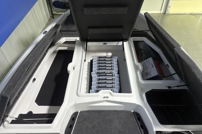Slide: The Image of 2026 Skeeter ZXE20 boat storage compartment with organized battery setup. - 12