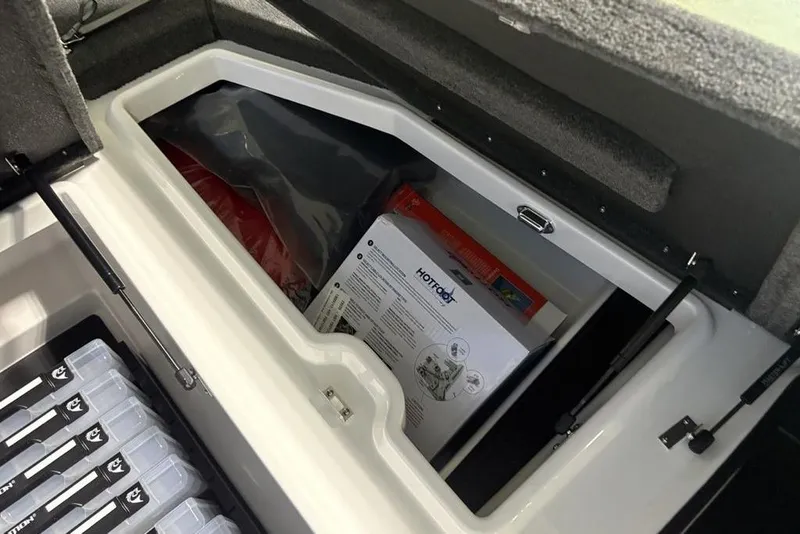 Slide: The Image of Storage compartment in 2026 Skeeter ZXE20 boat, featuring organized equipment and accessories. - 13