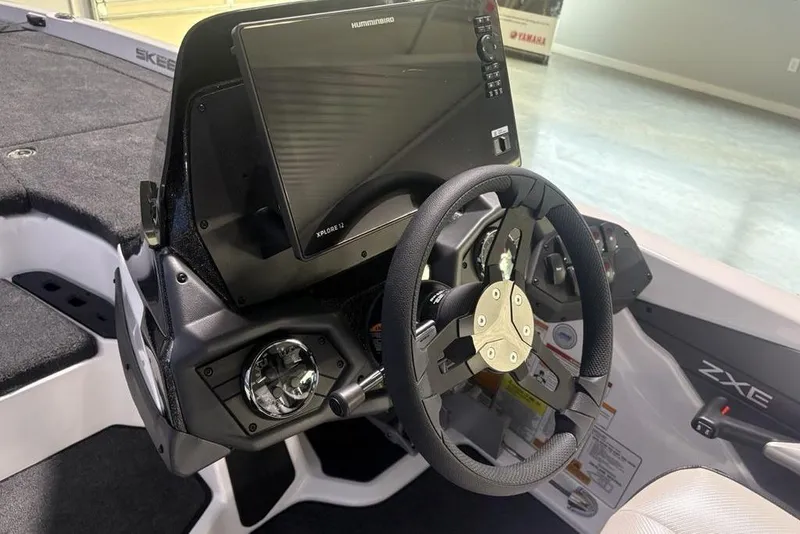 Slide: The Image of 2026 Skeeter ZXE20 boat dashboard with steering wheel and advanced navigation display. - 16