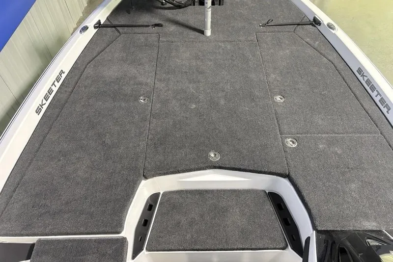 Slide: The Image of 2026 Skeeter ZXE20 boat deck with gray carpet and storage compartments. - 2