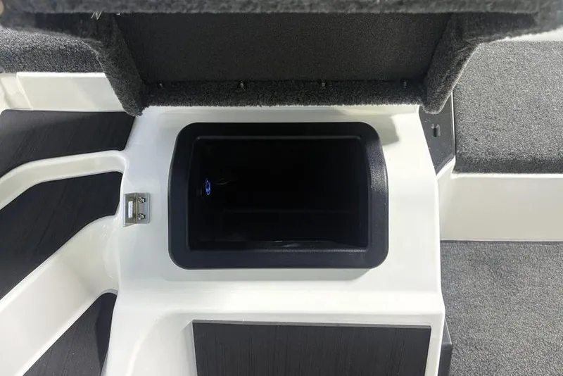 Slide: The Image of 2026 Skeeter ZXE20 boat storage compartment with open lid, showcasing interior space. - 20
