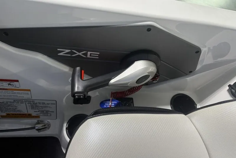 Slide: The Image of 2026 Skeeter ZXE20 boat control panel with throttle lever and safety features. - 27
