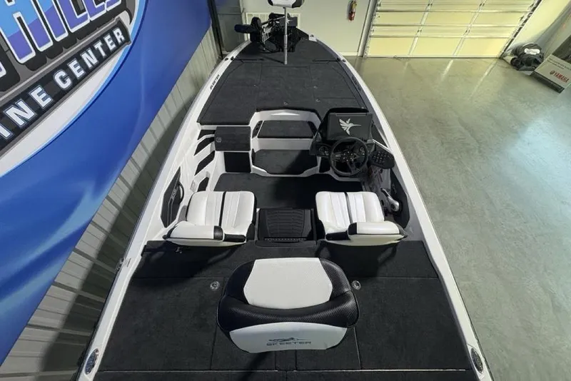 Slide: The Image of 2026 Skeeter ZXE20 boat interior with modern seating and steering console in showroom. - 31