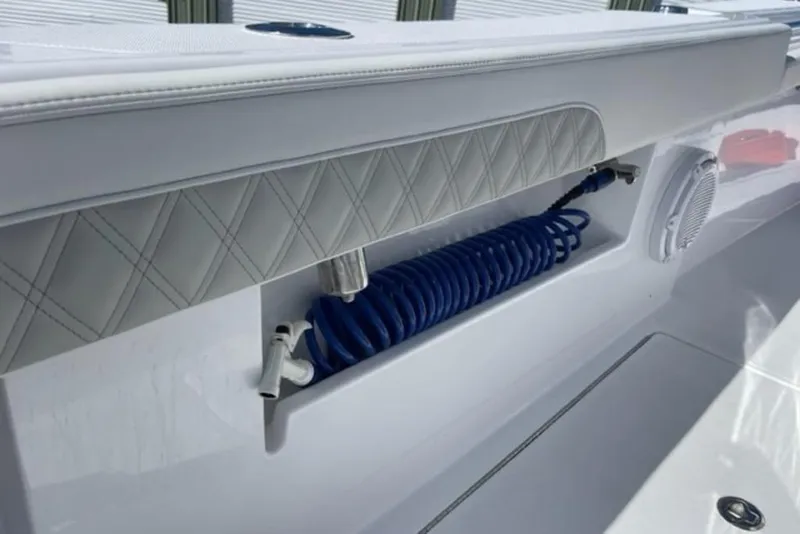 Slide: The Image of 2023 Front Runner 33 Center Console boat with coiled blue hose and speaker detail. - 13