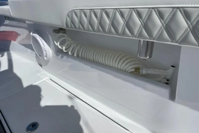 Slide: The Image of 2023 Front Runner 33 Center Console boat interior with coiled hose and speaker. - 14