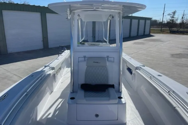 Slide: The Image of 2023 Front Runner 33 Center Console boat, sleek design, docked outdoors. - 16