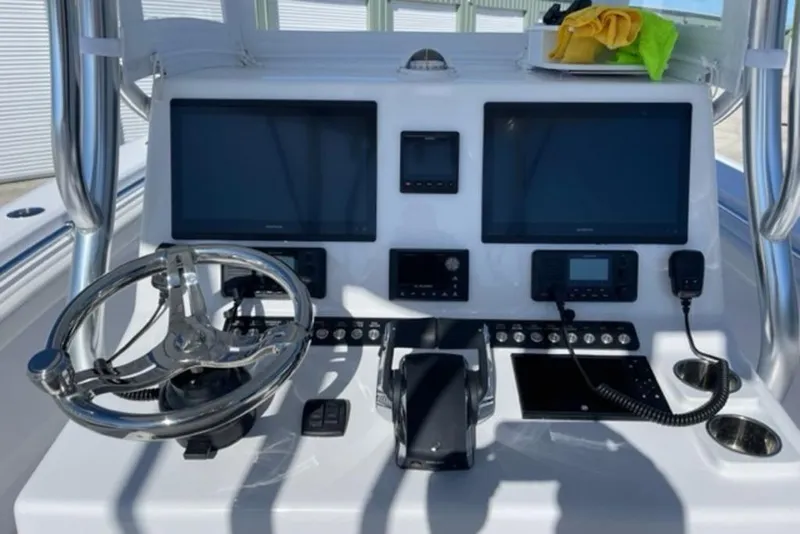 Slide: The Image of 2023 Front Runner 33 Center Console dashboard with dual screens and steering wheel. - 24