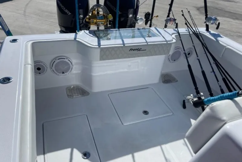 Slide: The Image of 2023 Front Runner 33 Center Console boat deck with fishing rods and speakers. - 26