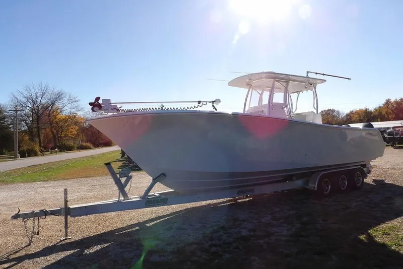 Slide: The Image of 2023 Front Runner 33 Center Console boat on a trailer under clear sky. - 3