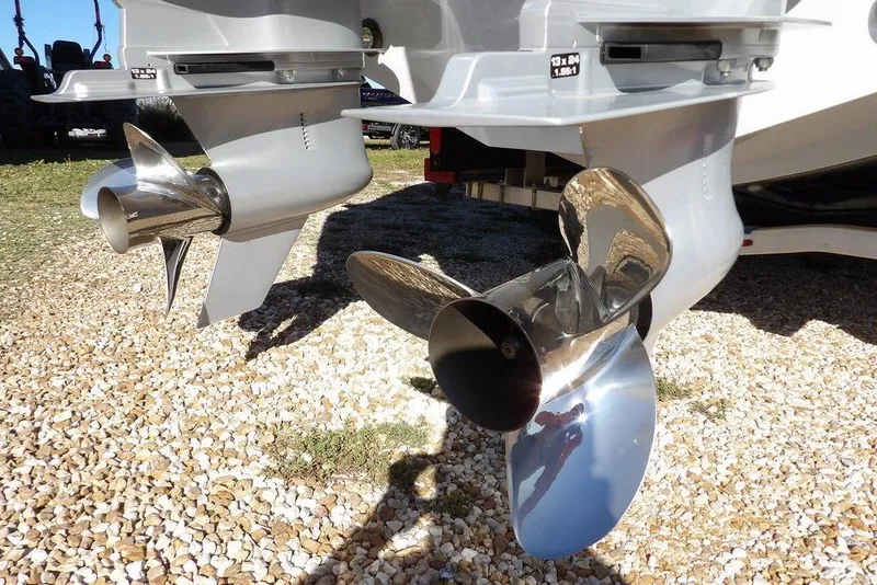 Slide: The Image of 2023 Front Runner 33 Center Console boat propellers on gravel surface. - 32