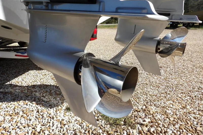 Slide: The Image of 2023 Front Runner 33 Center Console boat propellers on gravel surface. - 33