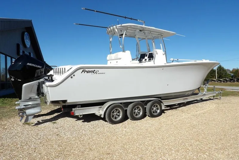 Slide: The Image of 2023 Front Runner 33 Center Console boat on trailer, side view, clear sky background. - 6